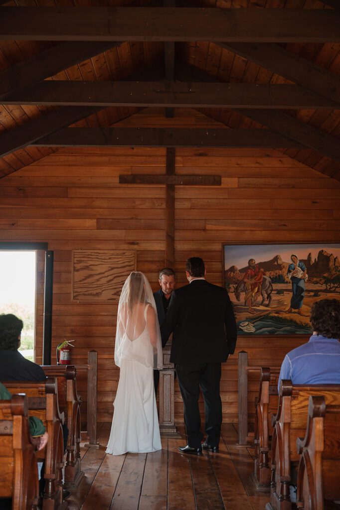 A wedding ceremony inside St. Rose Chapel at Jennings Holler