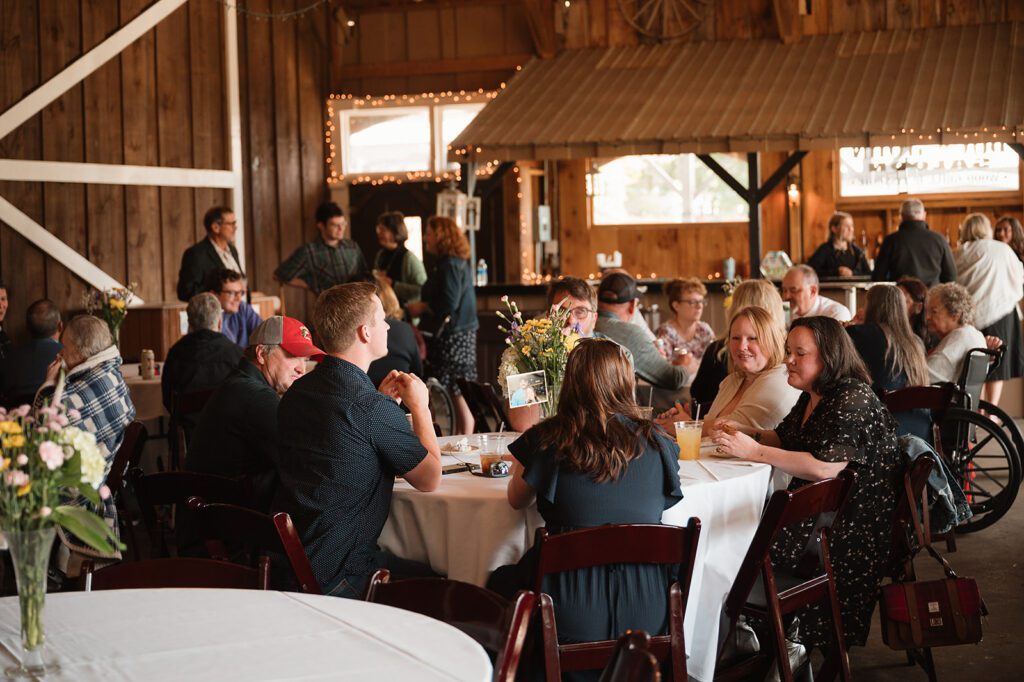 Wedding guests seated at tables in the Buckhorn Barn