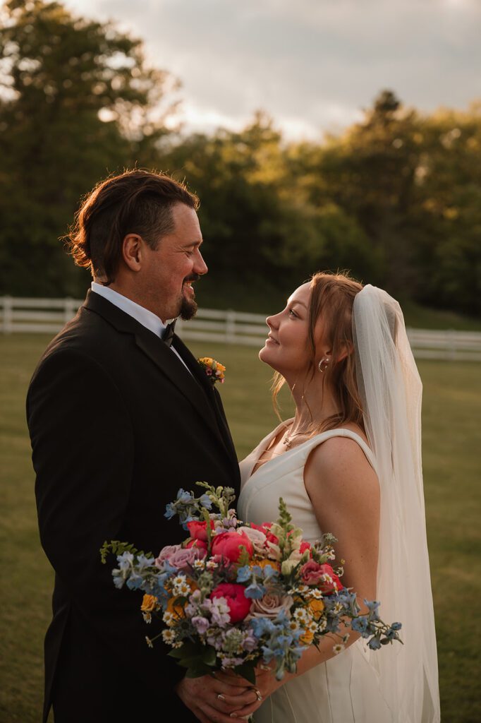 A bride and groom portrait with her bouquet