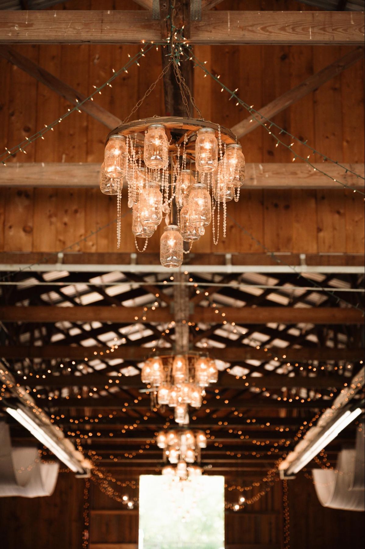 Mason jar chandeliers in the barn
