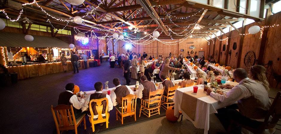 An autumn wedding reception filling the Buckhorn Barn at Jennings Holler, guests at long tables under string lights
