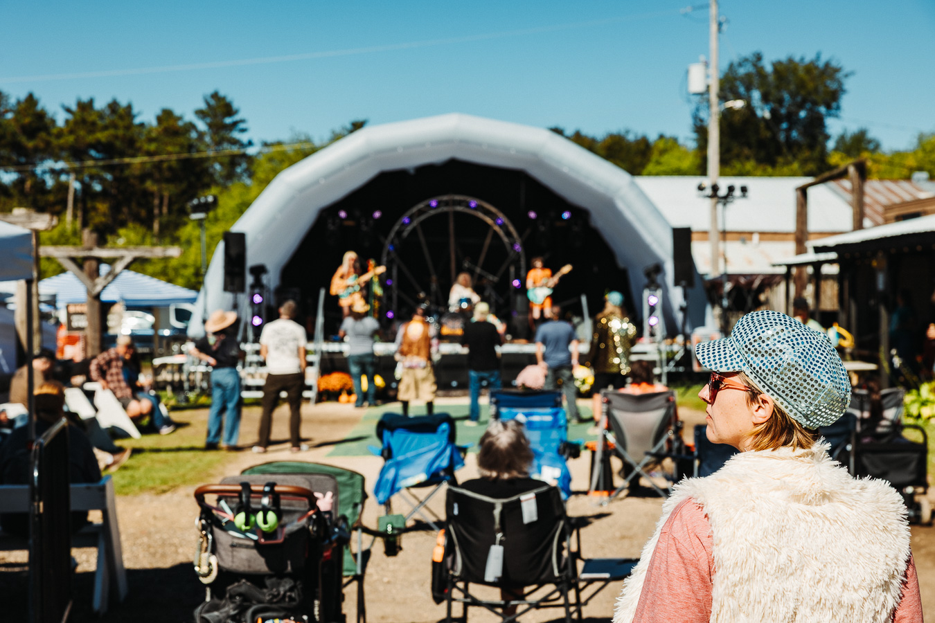 A daytime crowd in lawn chairs at the dome stage